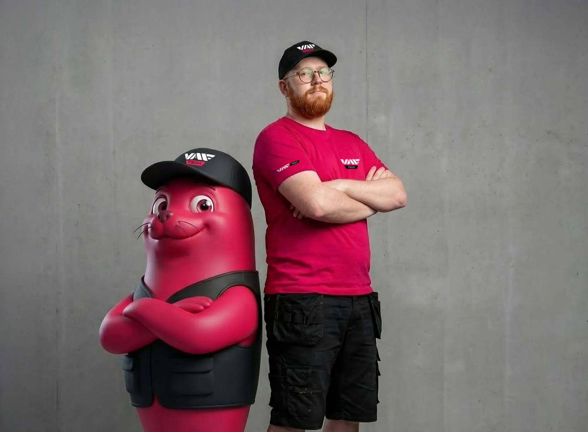 The Seal mascot standing next to a VAF Tech employee in a branded cap